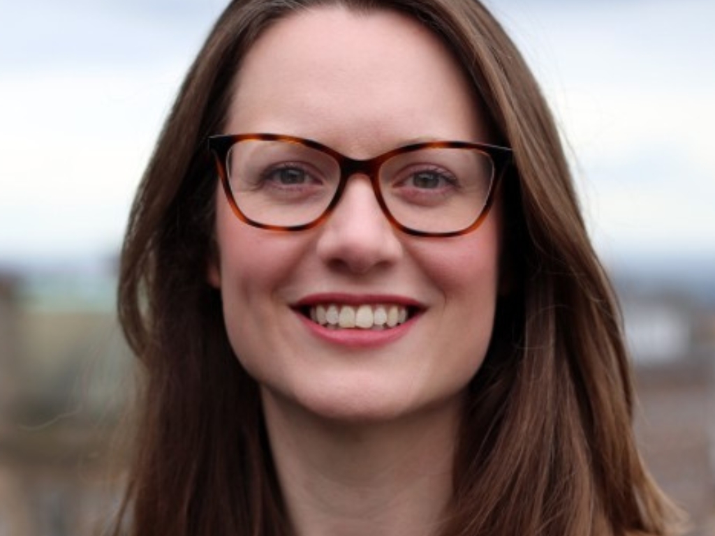 Image of Charlie Dixon who is a digital mindset coach. Charlie looks professional with long brown hair and distinctive glasses.
